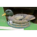 A metal doorstop in the form of a duck