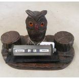 A carved owl on inkstand and a calendar