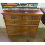 A yew and walnut small chest of two short and three long drawers