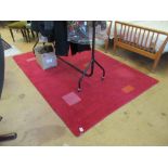 A red ground wool rug with geometric design