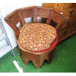 An oak circular chair with cushion