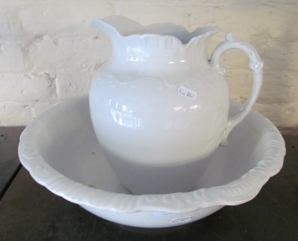 A white wash basin and jug