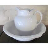 A white wash basin and jug