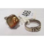 A silver ring set mother of pearl and another marked 925 PT
