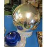 A silver coloured witches ball and a blue glass ball