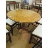 A pine circular tilt top table