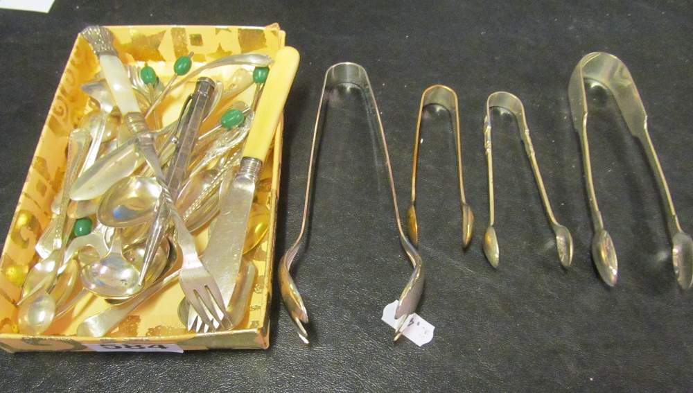 Various plated cutlery including sugar tongs