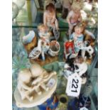 A Capodimonte cherub with dog and five other small figures cherubs and children