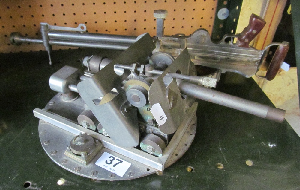 A metal gun sight mounted on base and another gun style instrument - Image 2 of 2