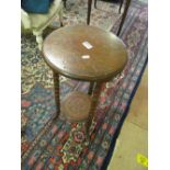 An Edwardian two tier occasional table on bamboo style supports