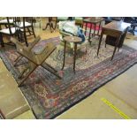 A Persian rug cream ground with birds and flowers surrounded by multiple blue and red floral