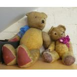 A 1950's straw filled Golden Plush teddy bear with glass eyes (well loved) and another large straw