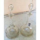 A pair of Edwardian decanters with long facetted necks etched vine leaf design