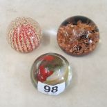 Three glass paperweights