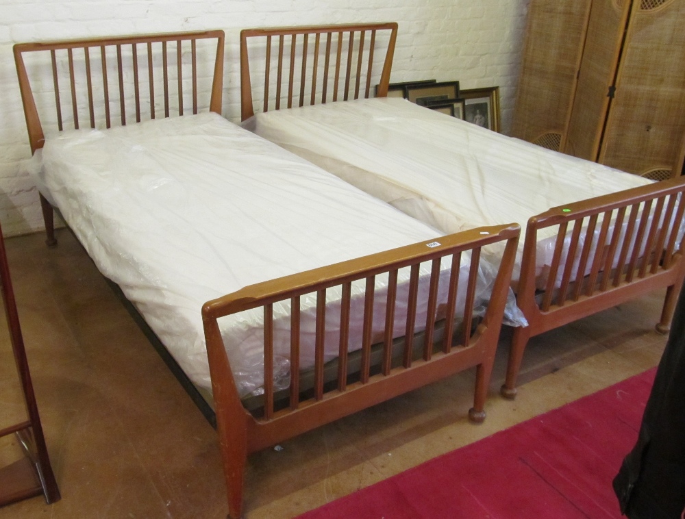 A pair of Heals single beds of slatted design with mattresses
