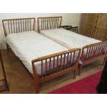 A pair of Heals single beds of slatted design with mattresses