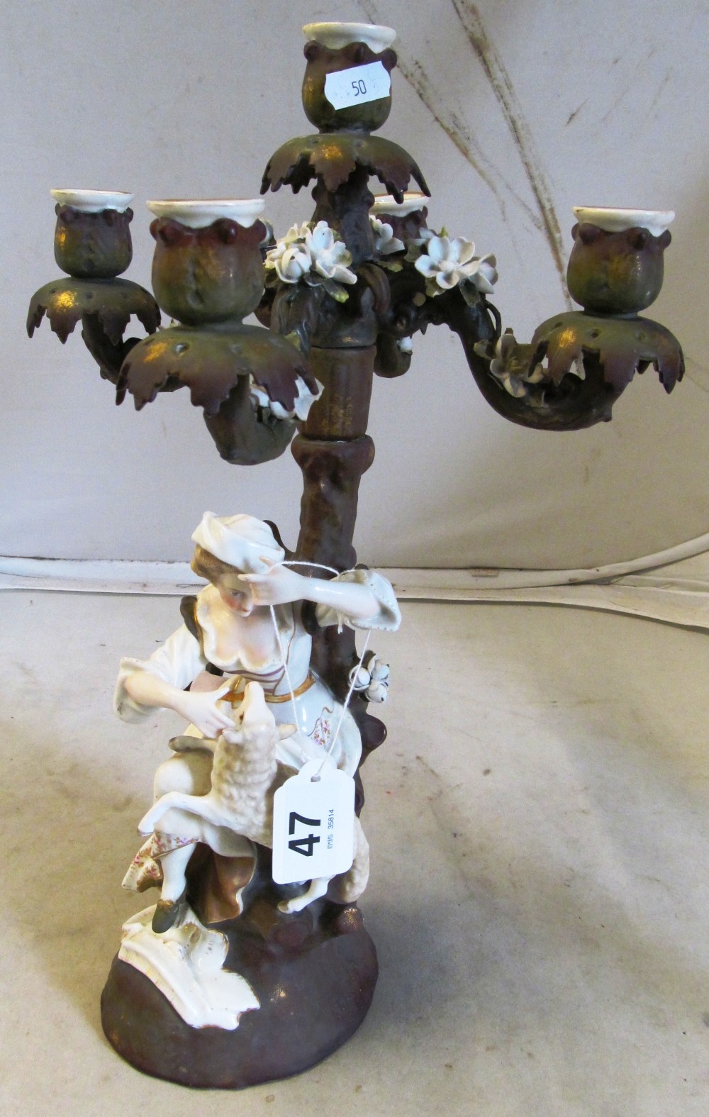 A 19th Century Sitzendorf style candelabra lady with sheep under a tree