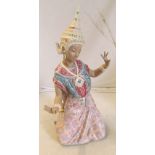 A Lladro figure Thai dancer kneeling (repair to wing of hat)