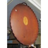 A mahogany shaped edge oval tray inlaid shell motif