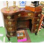 A kidney shape desk with five drawers on cabriole legs