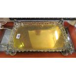 A brass and bronze rectangular tray with pierced edge and winged caryatid corners