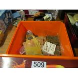 A box of mixed coins and slot machine coins