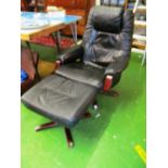 A black leather swivel reclining chair and footstool