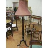 A mahogany standard lamp with tripod base