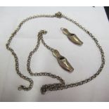 A pair white metal miniature shoes on guard chain