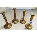 Two pairs of Georgian brass candlesticks with push-ups