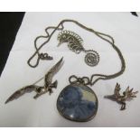 A silver chain with pendant, seahorse brooch, seagull brooch and another bird brooch