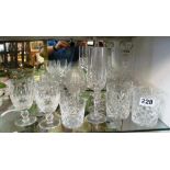 A cut glass decanter and various drinking glasses
