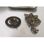 A marcasite brooch and military badge