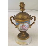 A Sevres style urn, hinged gilt lid on onyx base