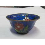 A miniature plique a jour bowl decorated flowers on a blue scale background