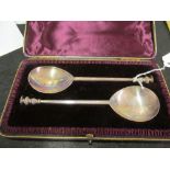 A pair of silver (London 1887) spoons with flat top baluster ends engraved with man with winged