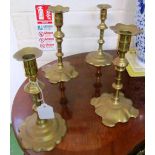 Two pairs of early Georgian brass candlesticks