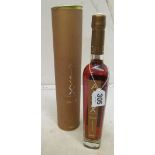 A bottle of Alexx V.S.O.P Cognac in tin