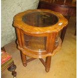 A walnut circular vitrine table