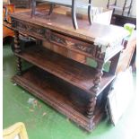 A late Victorian oak two tier buffet with two frieze drawers with mask handles on barleytwist