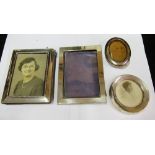 Four small silver photo frames