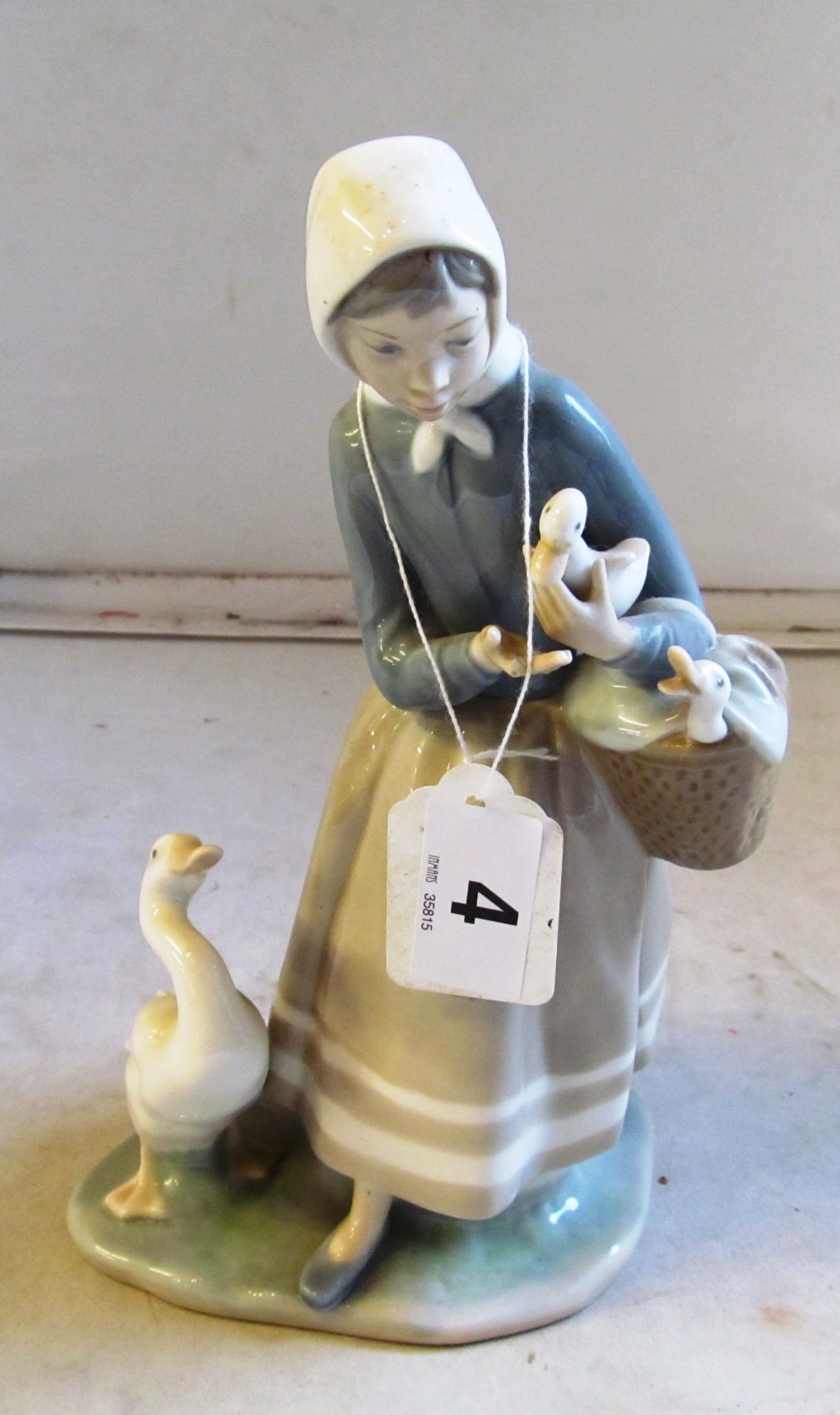 A Lladro figure girl with ducks (a/f) and two Lladro duck groups