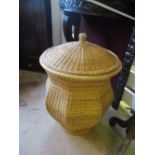 An Ali Baba wicker laundry basket with lid and linen lined interior