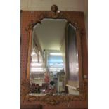 A gilt framed bevelled edge mirror with cupid head to cornice