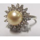 A pearl and diamond cluster ring marked 1180 SPC