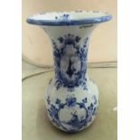A blue and white vase decorated dutch scenes with Delft mark under