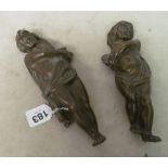 A pair of brass wall mounting cupid