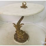 A pair of oval marble effect occasional tables on gilt dolphin bases
