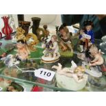 A 19th Century porcelain figure man with bagpipes and various other small porcelain figures