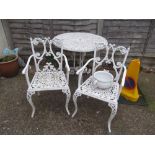 A white garden table and two chairs